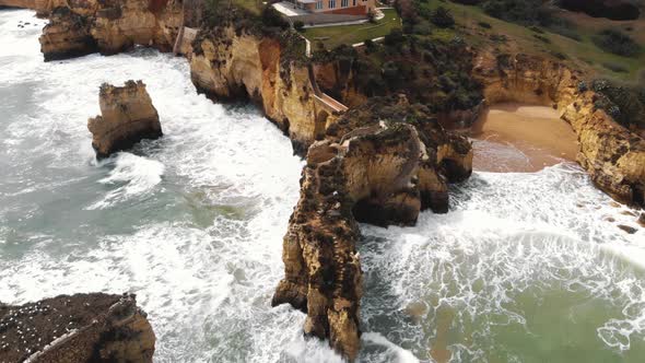 4k aerial drone footage of the rocky Ponta da Piedade limestone cliffs in Lagos, Portugal