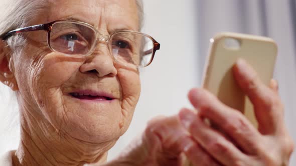 Joyous Senior Woman Using Smartphone