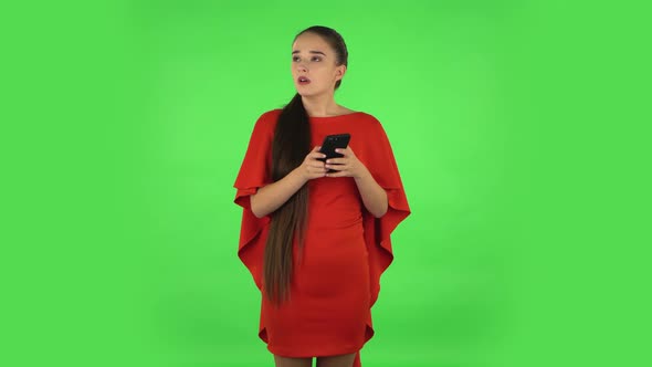 Pretty Young Woman Is Angrily Texting on Her Phone. Green Screen