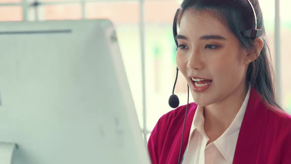 Businesswoman Wearing Headset Working Actively in Office