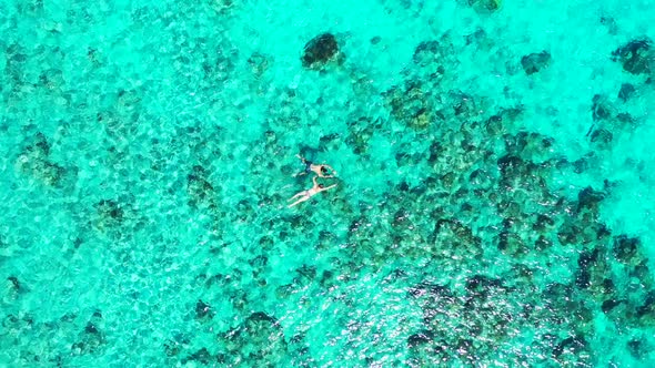 Aerial drone nature of marine shore beach trip by clear sea with white sandy background of a dayout 