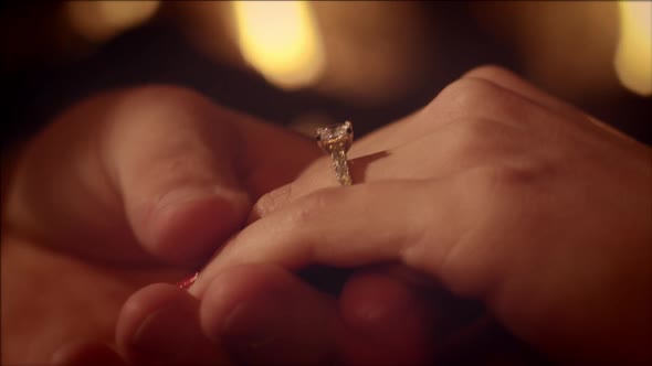 Man Putting On Engagement Ring Slow Motion