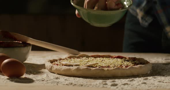 Male Hands of the Chef Preparing a Pizza with Mushrooms