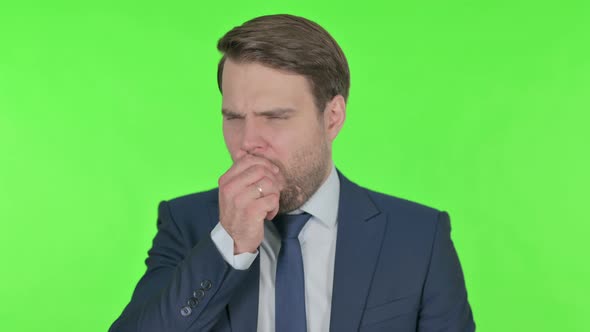 Young Businessman Coughing on Green Background