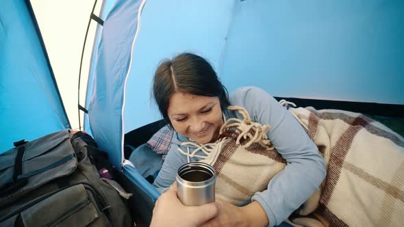 Awakening a Traveler Girl Sleeping in a Tent