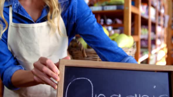 Female staff holding organic sign board