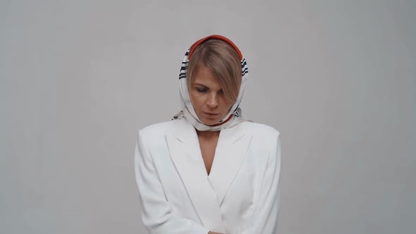 Beauty Woman with a Handkerchief on Hes Head Posing to Camera