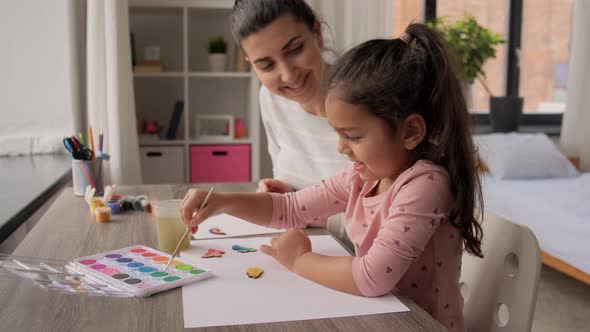 Mother with Daughter with Colors Painting at Home