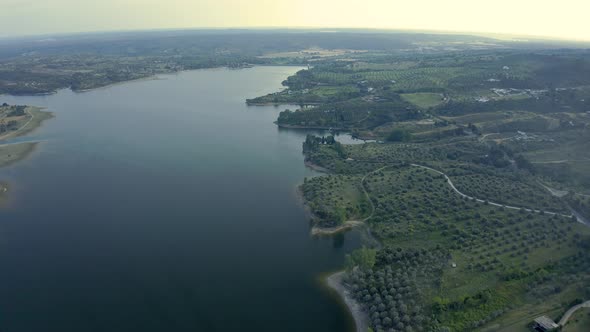 Aerial View Over A Mountain Dam In Portugal With some reflexions on water Before Sunrise