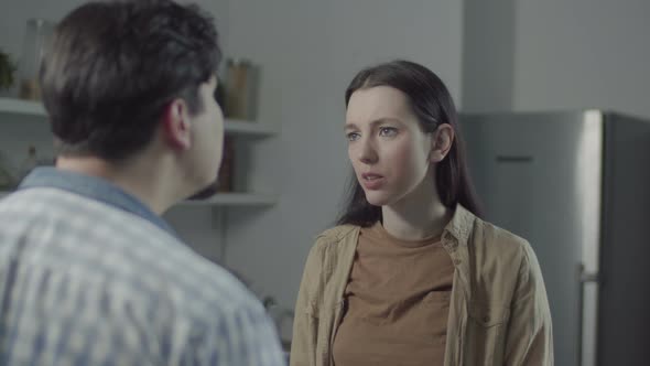 Man and Woman Aggressively Arguing in Kitchen