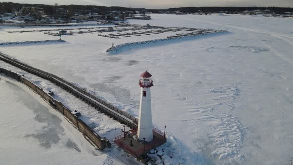 4k drone video of Wawatam Lighthouse in St. Ignace, Michigan during the winter.