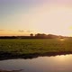 Aerial Cinematic Clip Drone Flying Over a Farm Field During Sunset - VideoHive Item for Sale