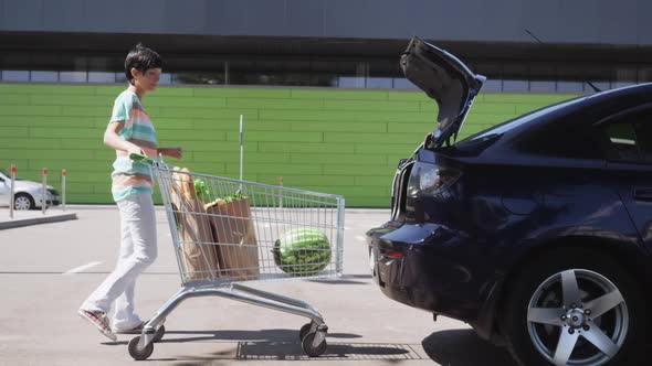 Girl with Foodstuffs Near Grocery Store