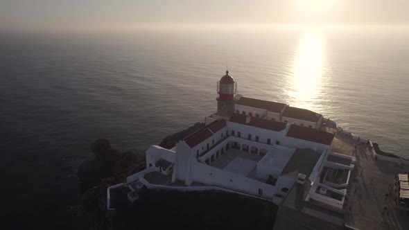 Cabo de Sao Vicente lighthouse against sunset sunbeam , Sagres, Algarve, Portugal