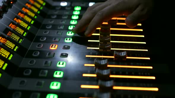 Producer Working with Control Desk in Studio