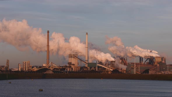 Factory Tata Steel with smoking chimneys on a sunny day in Holland