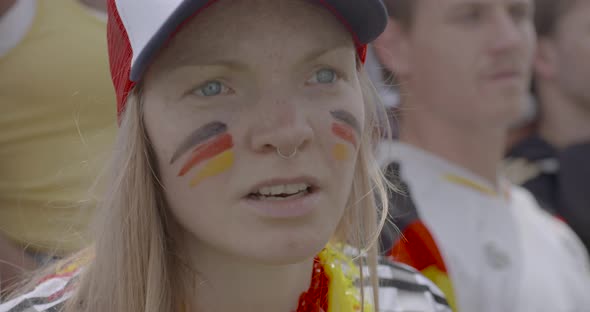 Female sports enthusiast watching match attentively, slow motion