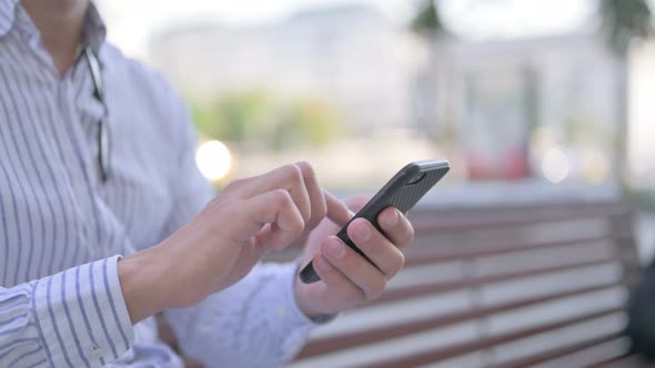 Close Up of Young Adult Man Using Smartphone Outdoor