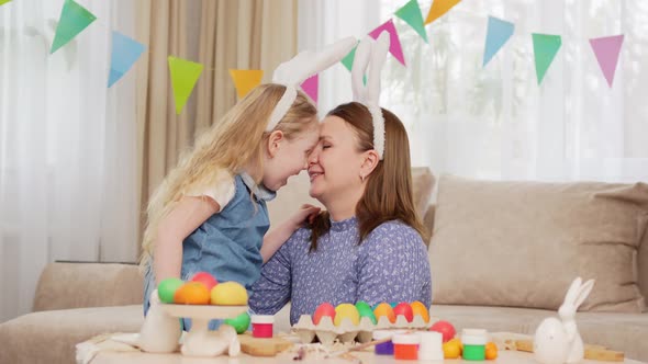 Mom and Little Daughter with Rabbit Ears Celebrate Easter and and Have Fun