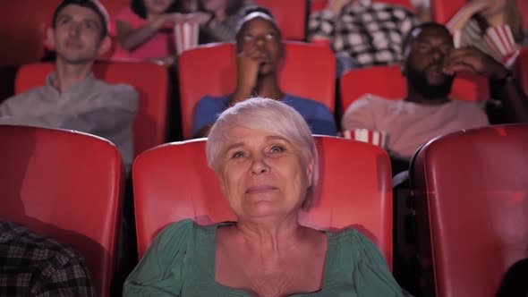 Pretty Aged Woman Enjoying Movie at Cinema