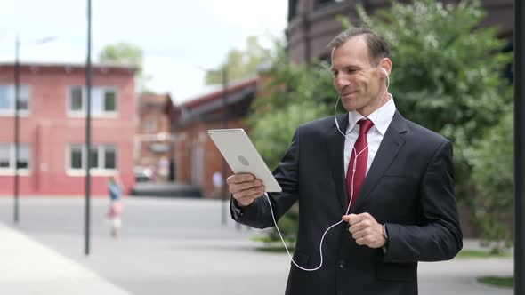 Online Video Chat on Tablet By Businessman