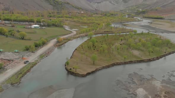 Aerial Above Ghizer River With SUV Parked On Rural Road. Follow Shot