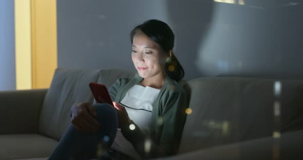 Woman look at mobile phone at home