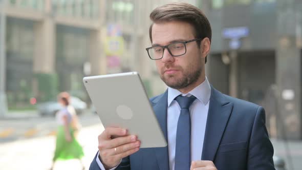 Businessman having Loss on Tablet Outdoor