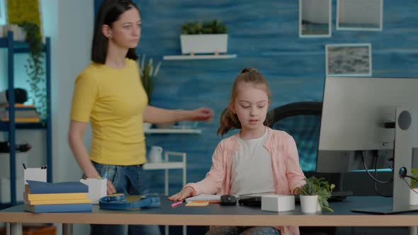 Young Child Asking for Help From Mother with Computer Work