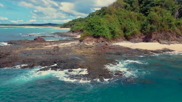 Drone footage of a wonderful island with a beautiful beach, low altitude forward movement