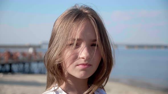 Closeup Portrait of a Little Cute Baby Girl Standing Near Beach