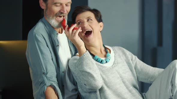 Aged Couple Sitting in the Kitchen