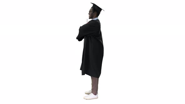 African American Male Student in Graduation Robe Folding Arms with Diploma Looking with a Big Smile