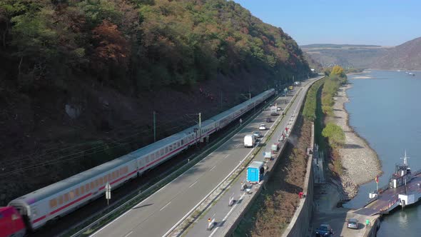 Commuter Train Passing Through a River Valley