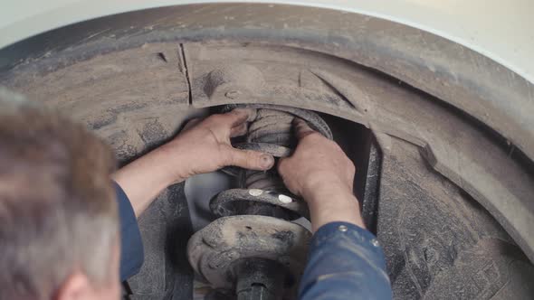 Mechanic Repairing Brake Discs in a Car Vehicle