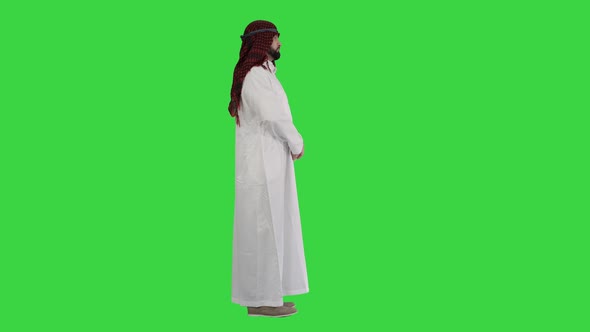 Arab Sheikh Wearing Keffiyeh Standing on a Green Screen, Chroma Key.