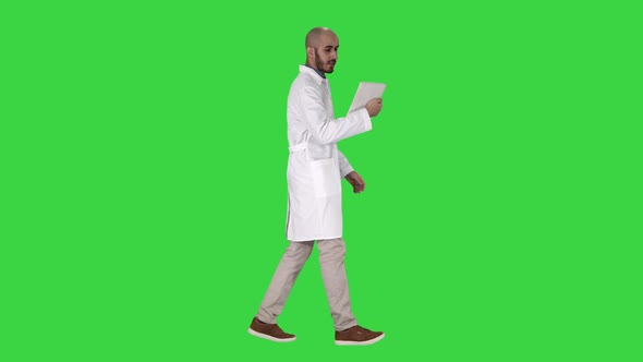 Sincere Doctor Making Video Call To His Patient Walking on a Green Screen, Chroma Key