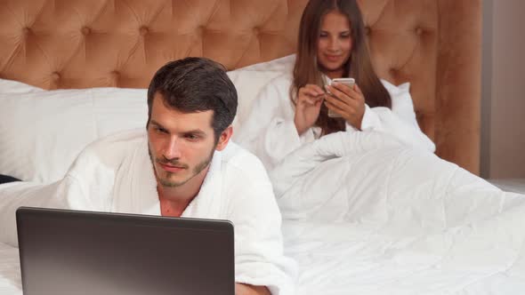 Handsome Man Working on His Laptop at the Hotel Room