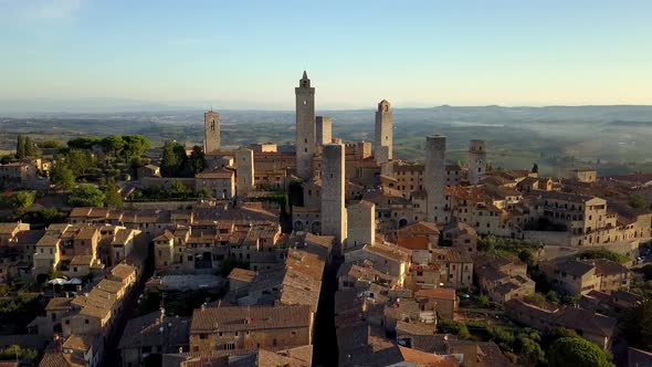 San Gimignano Italy with Torre Grossa and Duomo di San Gimignano visible, Aerial drone flyover shot