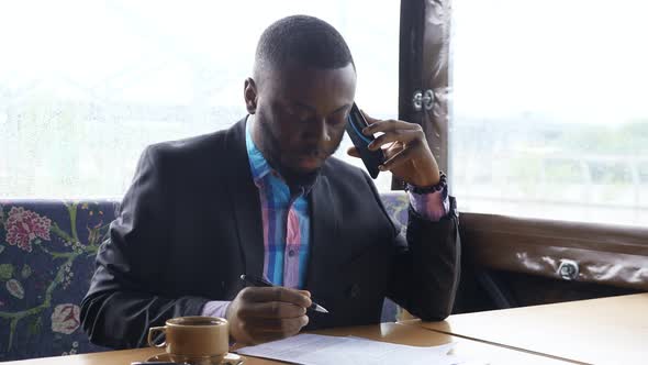 Afro American Businessman is Calling on Smartphone