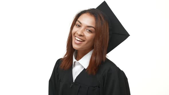 Smiling Happy Beautiful African American Female Graduate Showing Ok Over White Background in