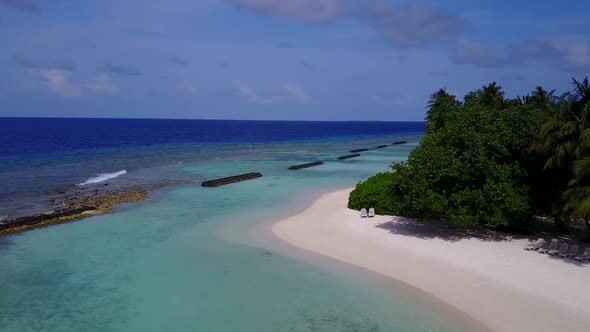 Aerial drone panorama of tourist beach by clear water and sand background