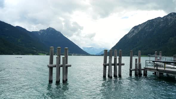 Beautiful Achensee lake near pier for ships during holiday vacation in Austria.Static wide shot.