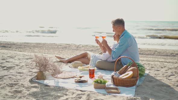 Beautiful Lovely Couple Having Romantic Date at Sea Beach Feeding Each Other By Fruits