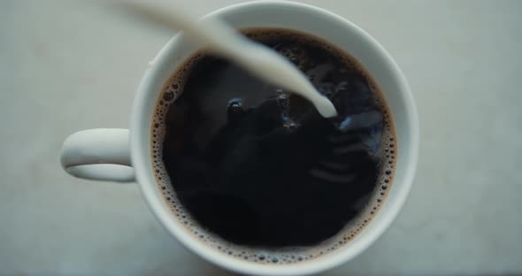 Pouring Milk in Coffe in Cafe Top View Super Slow Motion