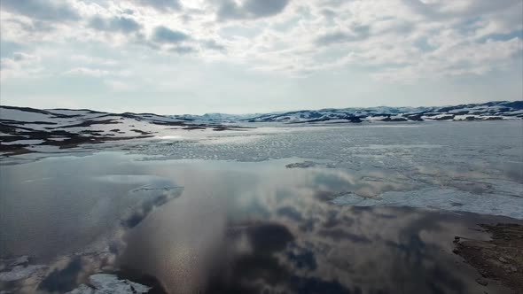 Calm waters of freezing lake in Norway, aerial view.