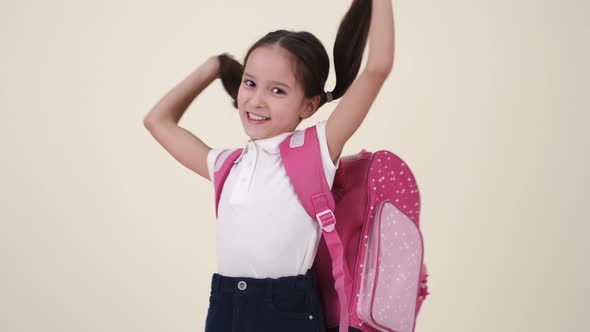 Little School Girl with Backpack and Uniform on White Back
