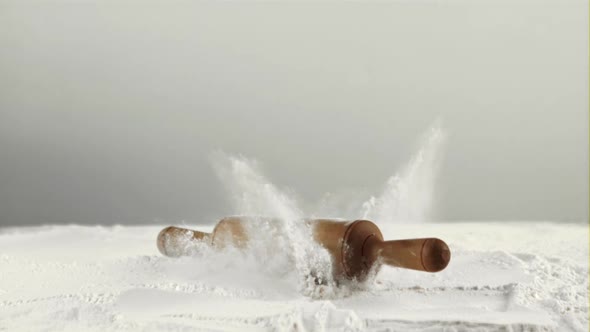 Super Slow Motion in the Flour Falls a Wooden Rolling Pin