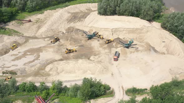 Industrial equipment at mining area. Sky view of mining equipment at sand mine. Mining conveyor work