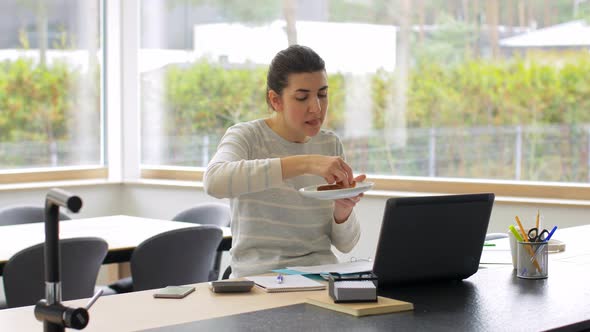 Woman with Laptop and Papers Works at Home Office